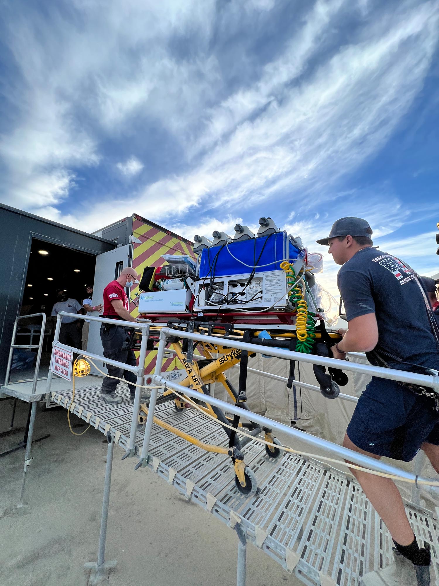 staff loading medical gear into trailer